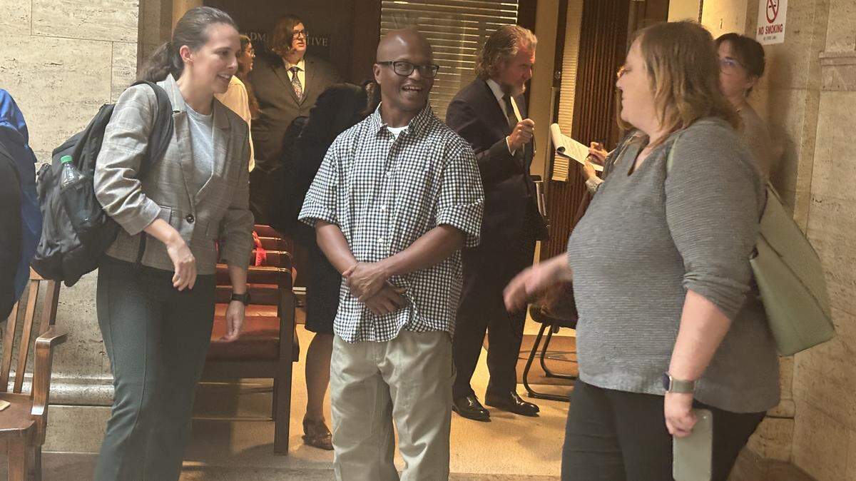 Celester McKinney, middle, stands outside of a Wyandotte County courtroom on Wednesday, May 6, during an evidentiary hearing for potentially a new trial.