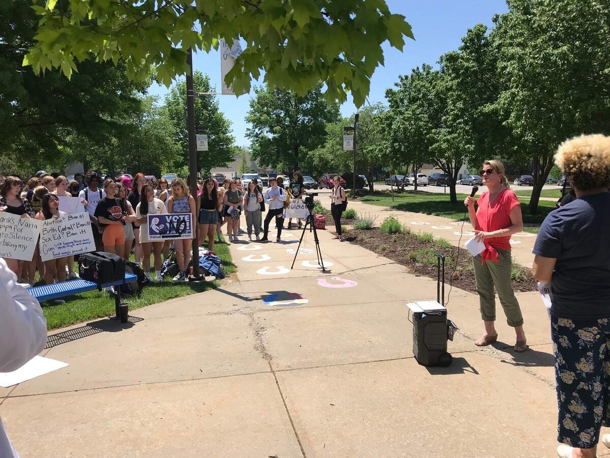 Kansas State Senator Cindy Holscher, right, speaks to around 200 Blue Valley North High School students at a walkout protest over Roe v. Wade on Thursday, May 12.