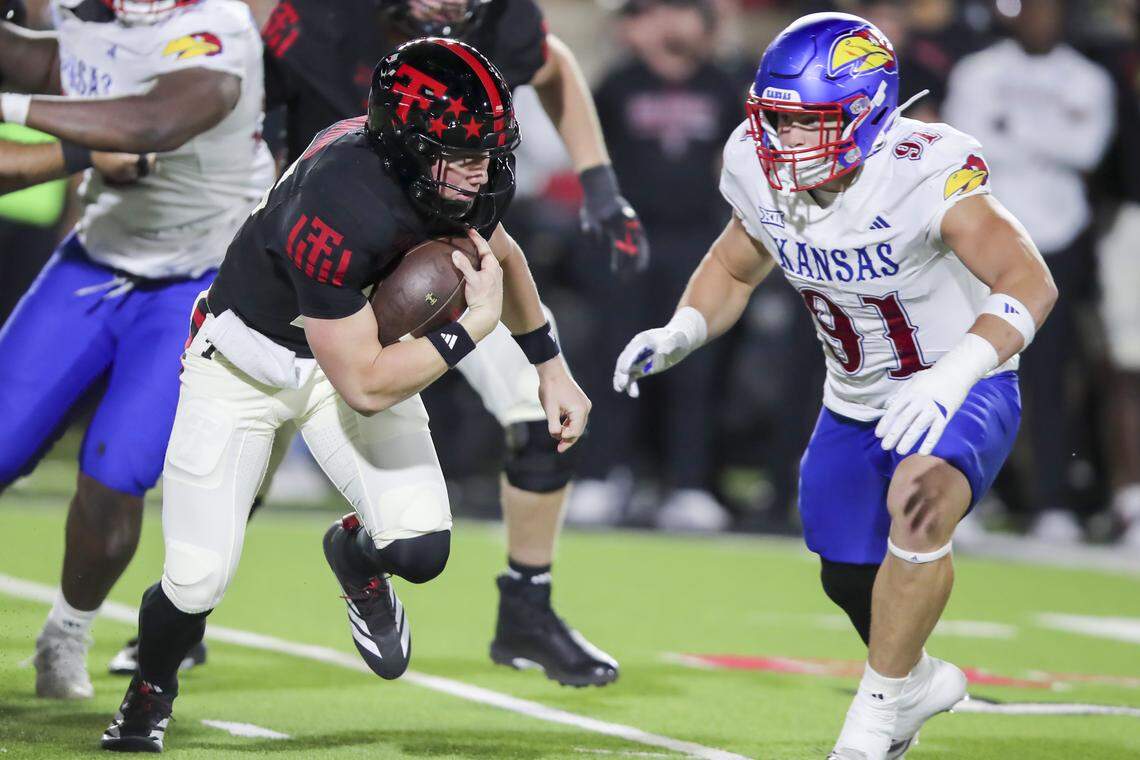 Texas Tech Red Raiders quarterback Will Hammond (15) rushes in the first half against Kansas Jayhawks defensive end Alex Bray (91) at Jones AT&T Stadium on Oct. 11, 2025.