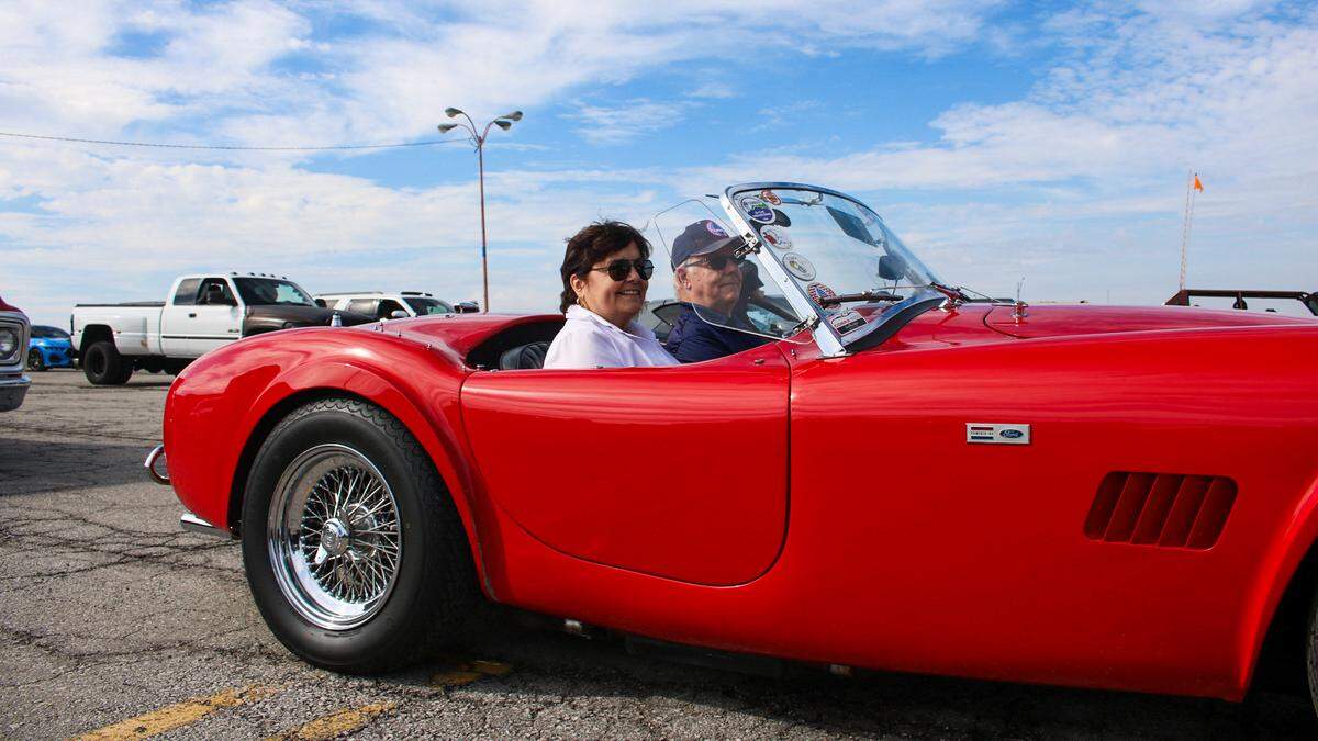 Penny Sharp, 79, and Jim Sfptko, 80, sit in their 1964 AC Cobra 289 before a parade honoring Tucker Langford on Saturday, Oct. 11, 2025.
