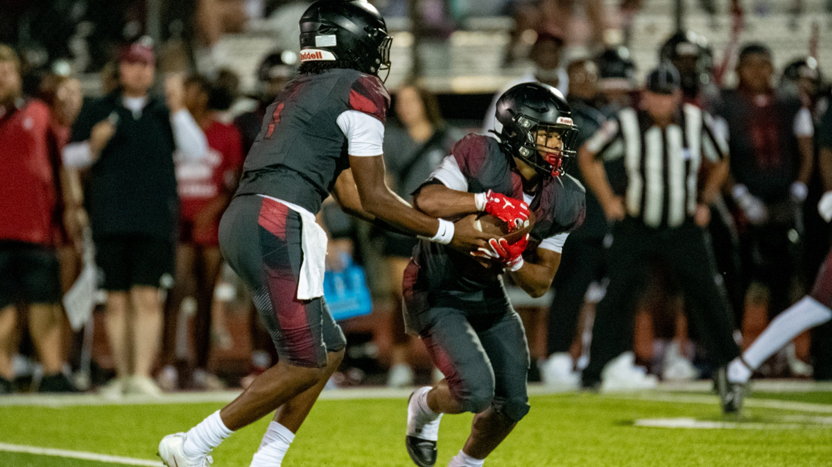 Stephen Thomas hands off to Bryce Thompson during Lee’s Summit North’s 31-21 high school football win over Mill Valley in Lee’s Summit on Friday, Sept. 12, 2025.