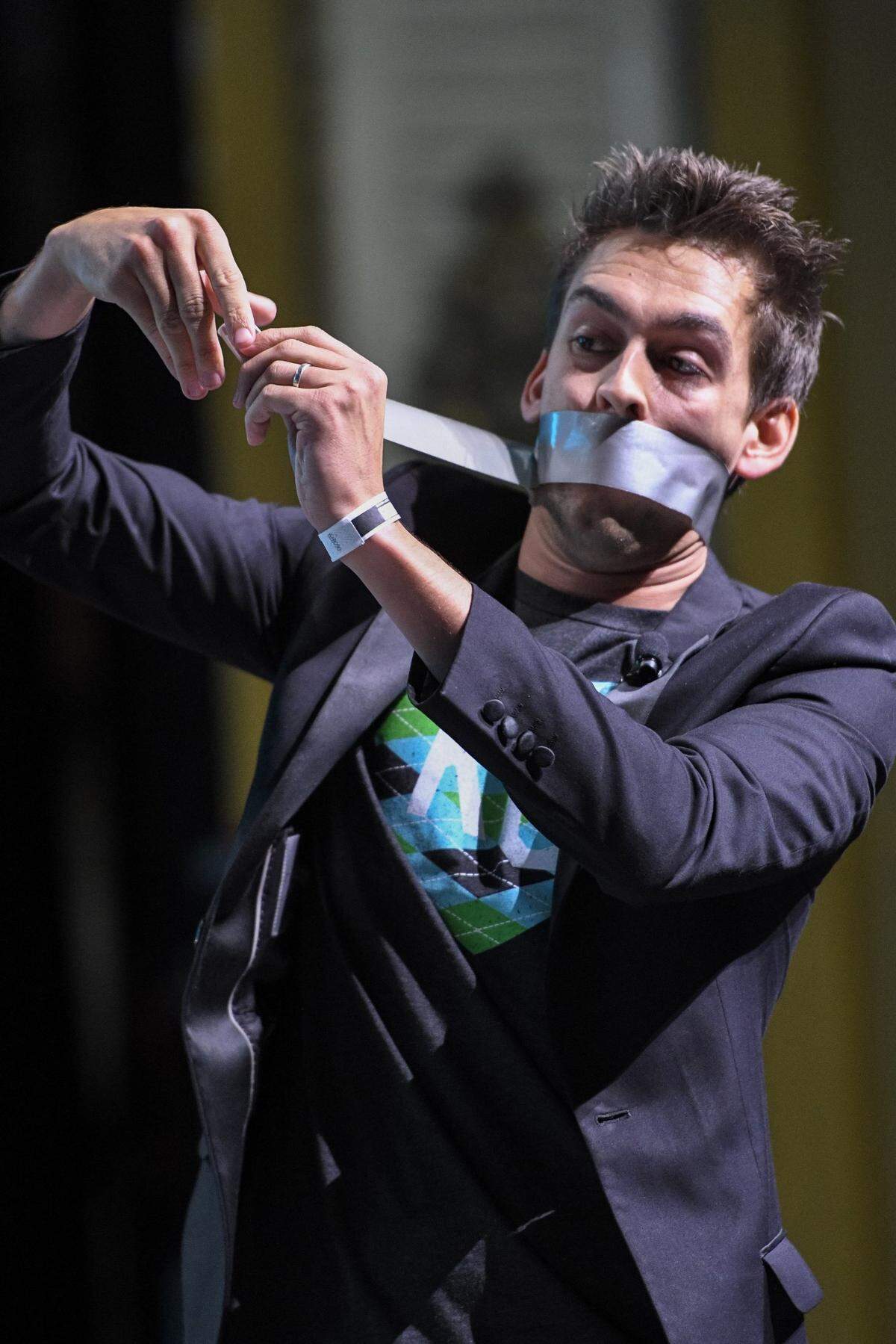 Magician Blake Vogt taped his mouth shut for one of his tricks to entertain the audience at the 2017 Big Slick auction.