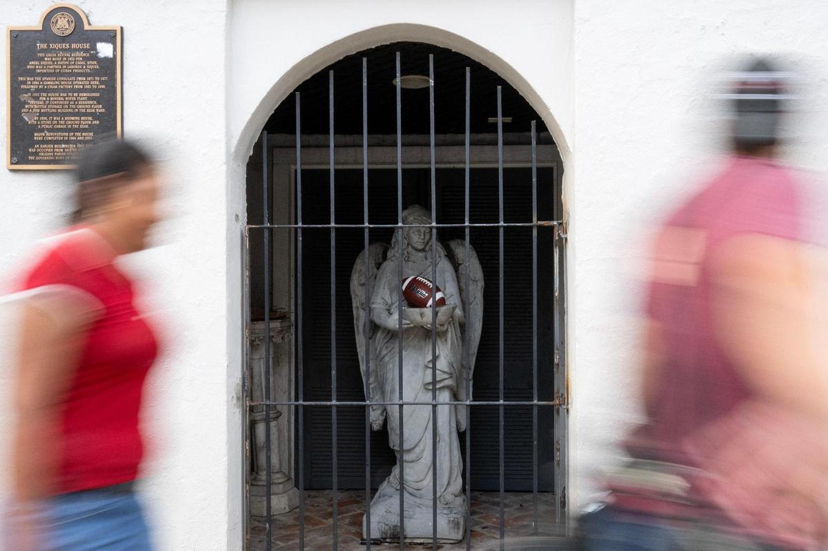 People walk past the Xiques Mansion along Dauphine Street on Wednesday, Feb. 5, 2025, in New Orleans.