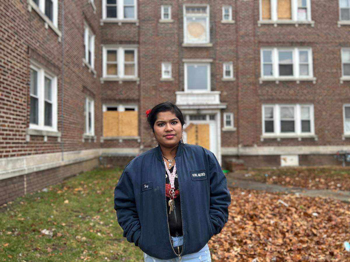 Sofia Be, a resident, stands in front of her home. She feels the owner and property managers of the building do not take their responsibilities seriously.