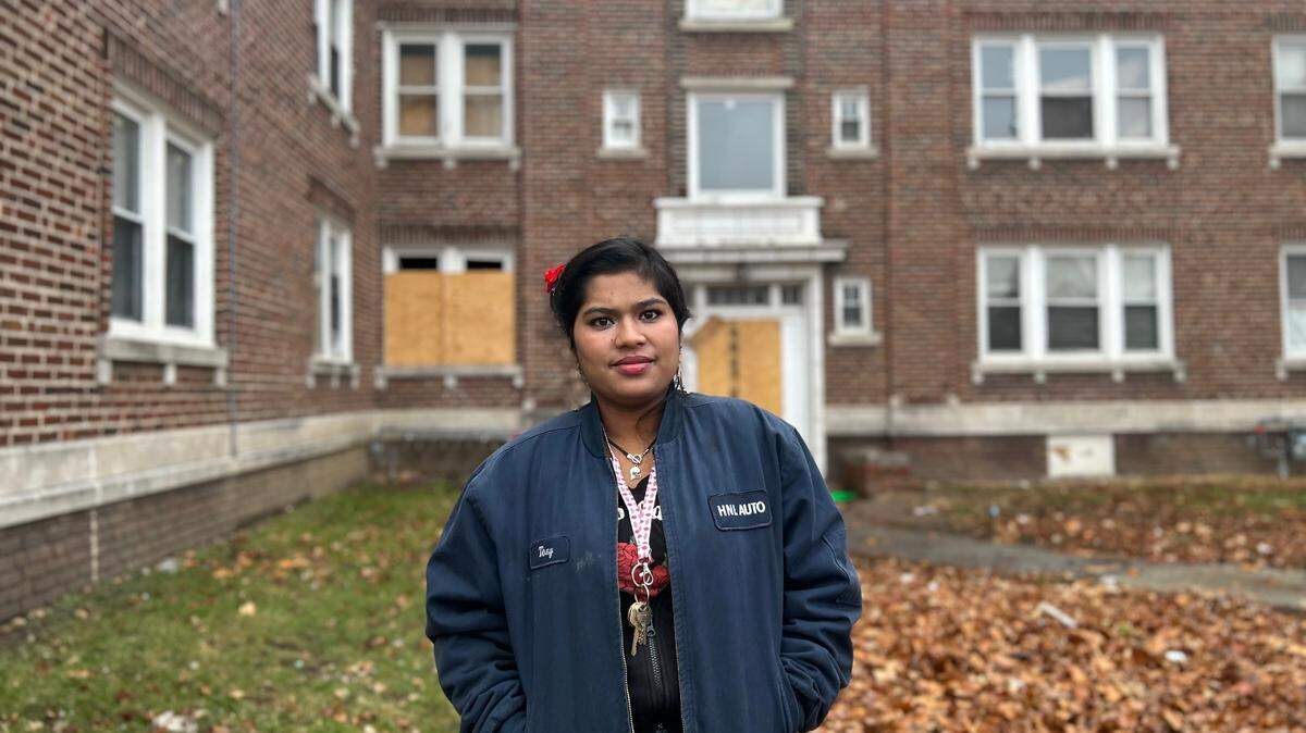Sofia Be, a resident, stands in front of her home. She feels the owner and property managers of the building do not take their responsibilities seriously.