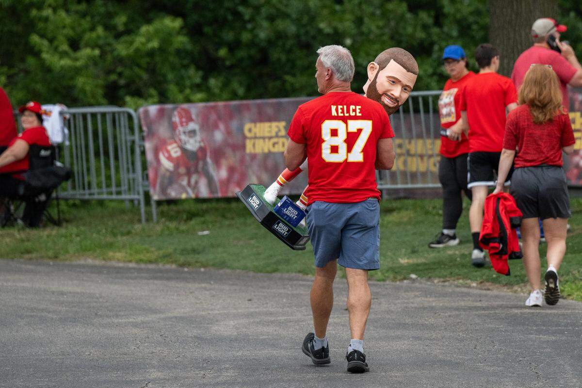 Brian Abbott walks with his life-sized Travis Kelce bobblehead at Chiefs training camp in St. Joseph.