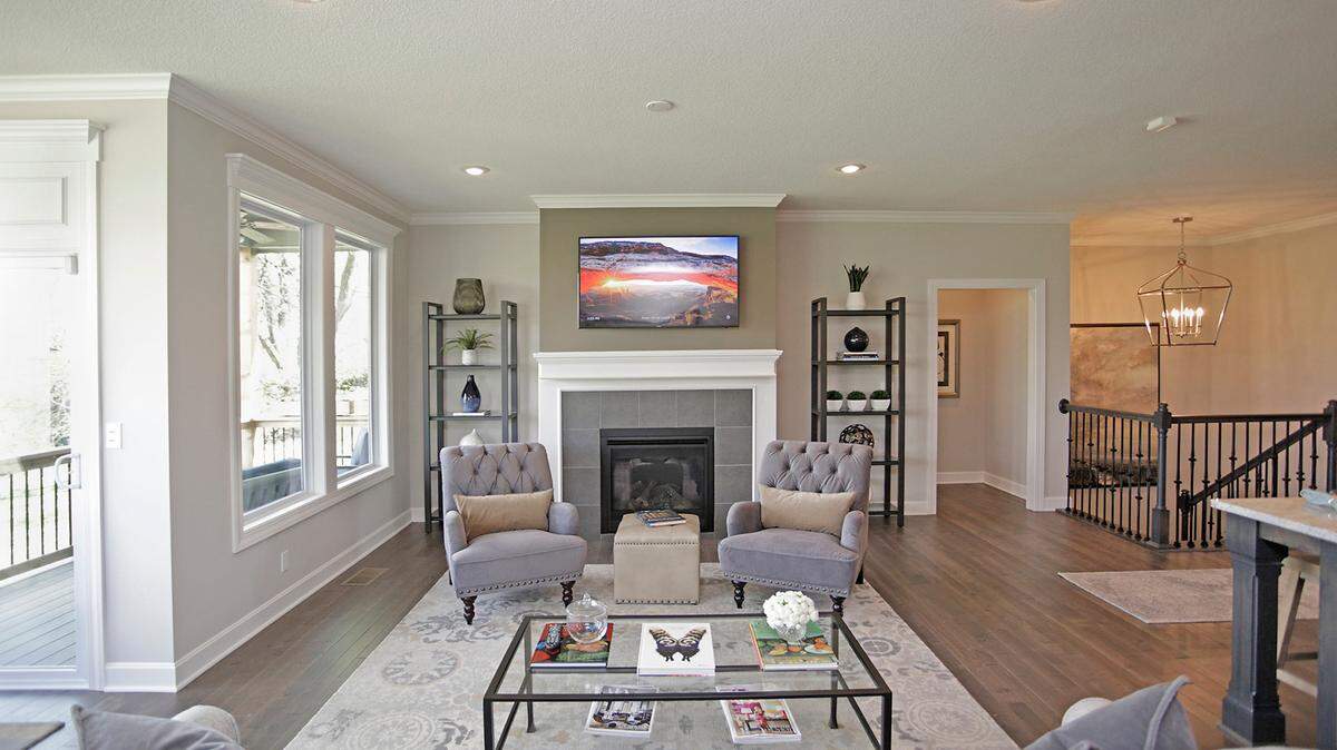 The open living room provides a cozy gas fireplace for evenings at home or family gatherings. Surrounded by oversized windows and open to the dining room and chef-inspired kitchen, the spacious living area also provides the perfect flow for effortless entertaining.