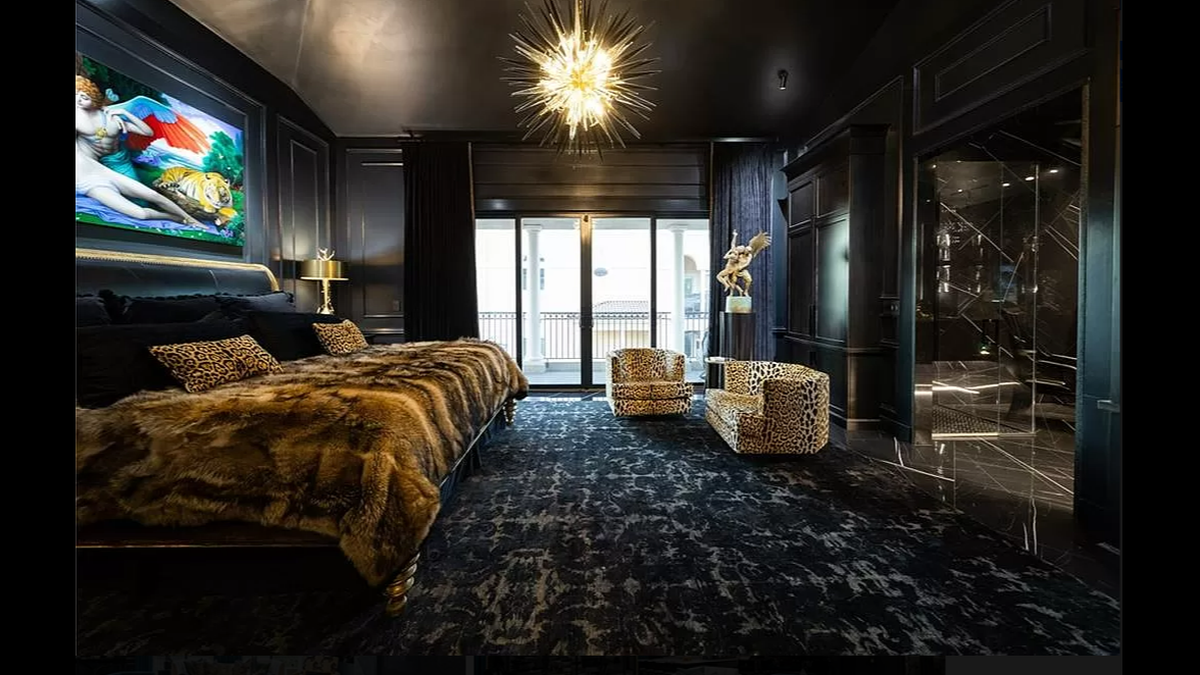 One of two private suites inside the Kansas City condo at 4 E. 51st St. The suite includes a private bathroom, patio, walk-in closet and glass shoe display.