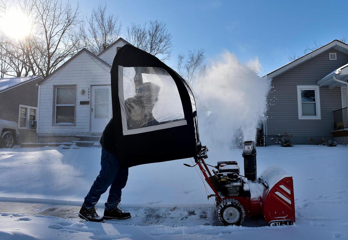 Like a good neighbor, a North Kansas City resident uses a snow blower to clear the sidewalks on his street Tuesday, Feb. 16, 2021. The man, who declined to give his name, said neighbors had been calling him to do their sidewalks. “It’s better than shoveling,” he said.