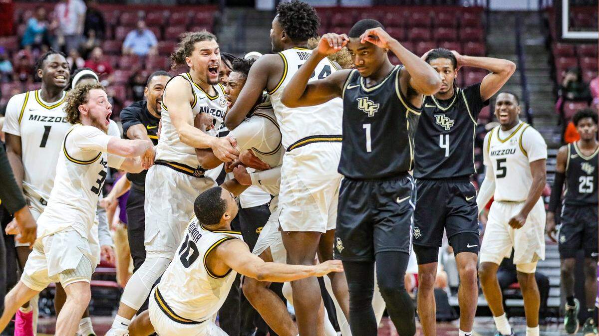 Missouri celebrates on the court after scoring at the buzzer to defeat the UCF Knights during the Orange Bowl Classic at FLA Live Arena in Sunrise on Saturday, December 17, 2022.