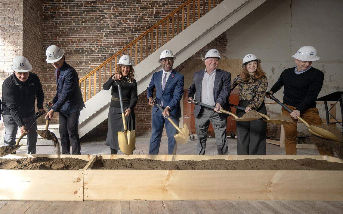 A groundbreaking ceremony for the new River Market Hotel at 415 Delaware St. was held on Tuesday, Dec. 9, 2025, attended by Craig Scranton of BNIM, from left, owners Gino and Petra Serra, Mayor Quinton Lucas, Patrick Gideon of Silver Lake Bank, and owners Susan and Mike Heitmann. Others from Cerris Builders, BNIM, and Populous were also on hand for the event. The project will transform a historic building into a 45-room boutique hotel, with plans to open in the spring of 2026.