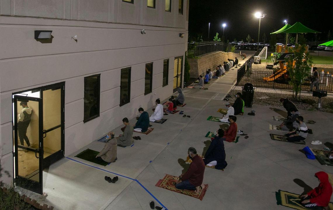 Muslims pray on the evening of May 8, 2021, in an overflow area outside the Islamic Center of Johnson County, Kansas.