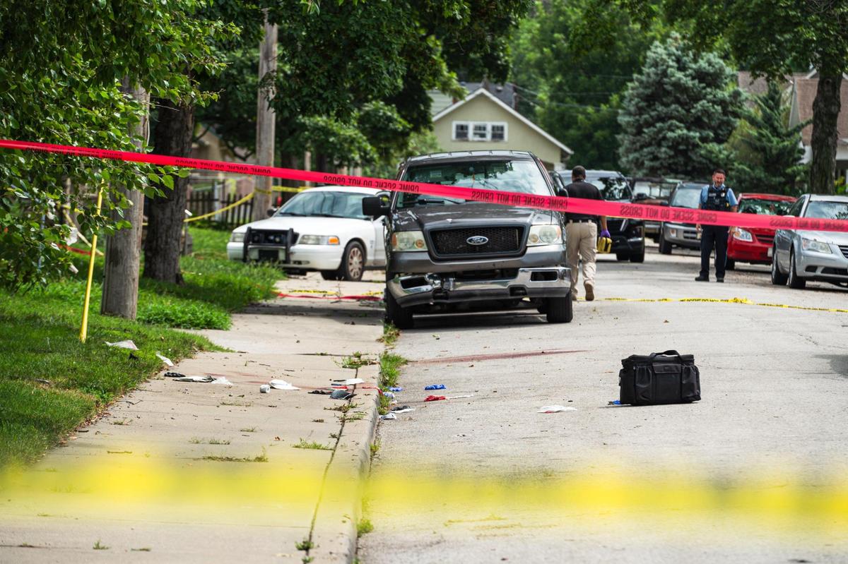 Police block off the scene of an officer involved shooting near the corner of Strong Avenue and South 37th Street on Tuesday, July 18, 2023, in Kansas City, Kan. According to a statement from the department, officers shot a person who was suspected of stabbing two people, one fatally.