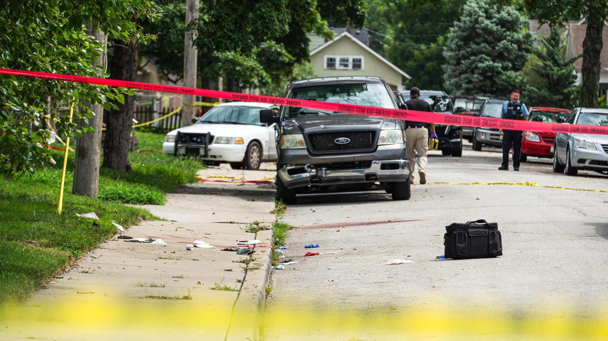 Police block off the scene of an officer involved shooting near the corner of Strong Avenue and South 37th Street on Tuesday, July 18, 2023, in Kansas City, Kan. According to a statement from the department, officers shot a person who was suspected of stabbing two people, one fatally.