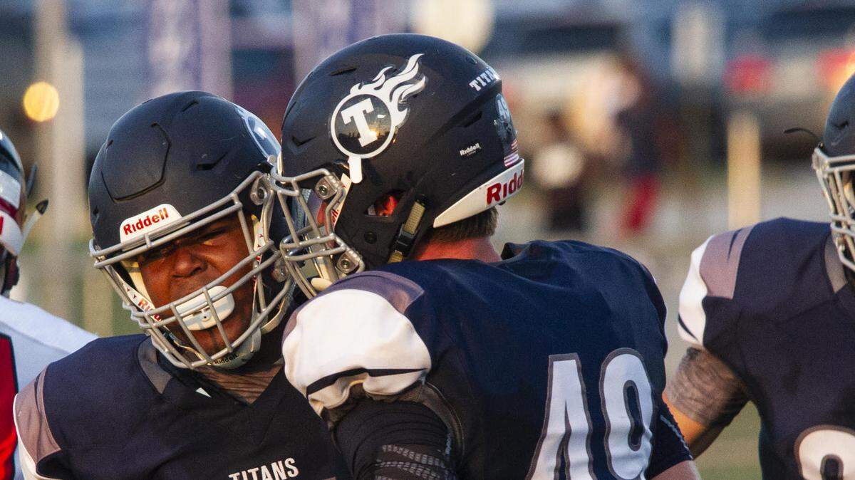 Lee’s Summit West defensive lineman Hampton Minniefield (left) celebrated with Elliott Keys after making a tackle against Park Hill at Lee’s Summit West in the season opener Friday night.