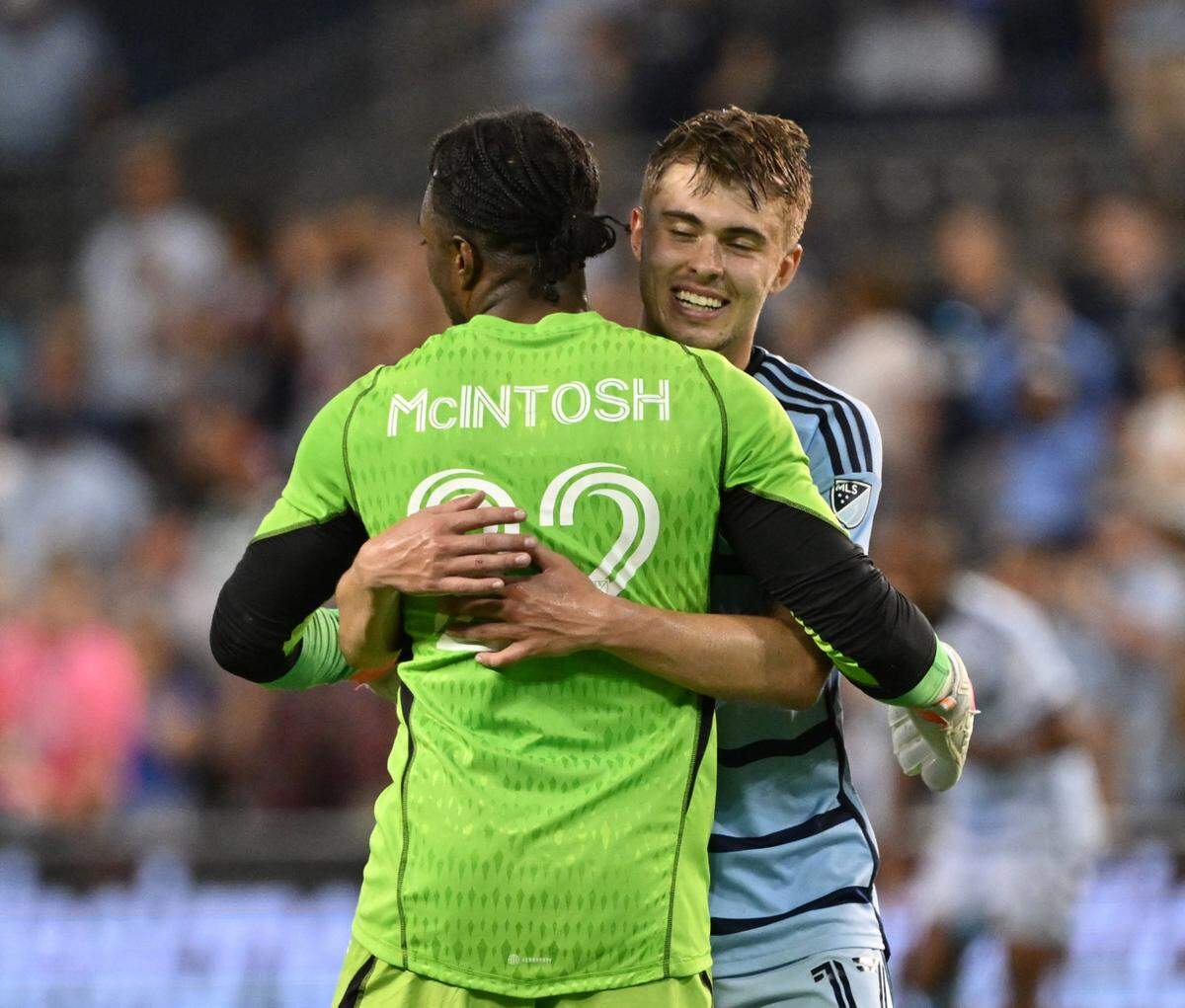 Sporting Kansas City’s Kendall McIntosh (22) and Jake Davis (17) celebrate their win against Minnesota United FC after the game at Children’s Mercy Park on May 13, 2023.