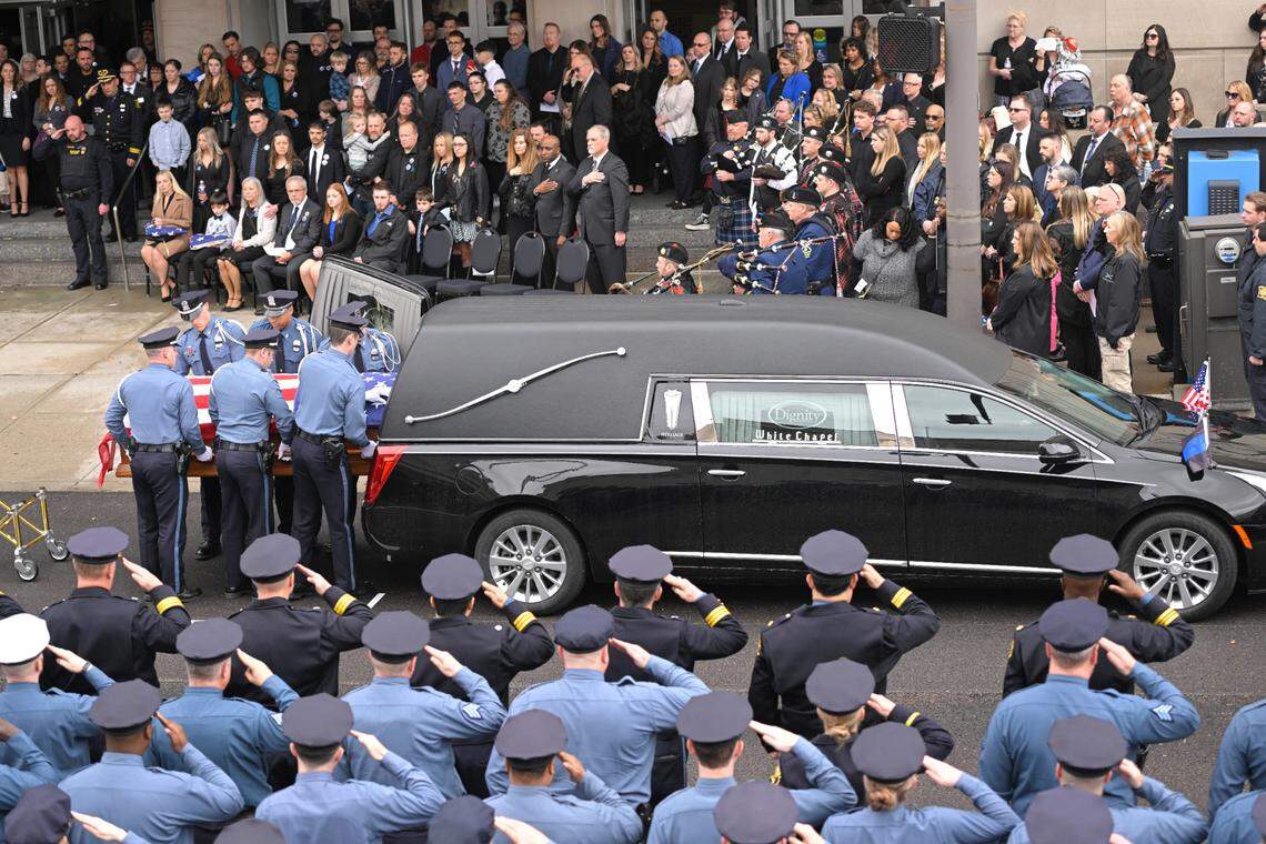 Police Officer James Muhlbauer,’s casket was loaded into a hearse after the funeral for Muhlbauer and his police K-9, Champ, Wednesday at Municipal Auditorium in Kansas City.