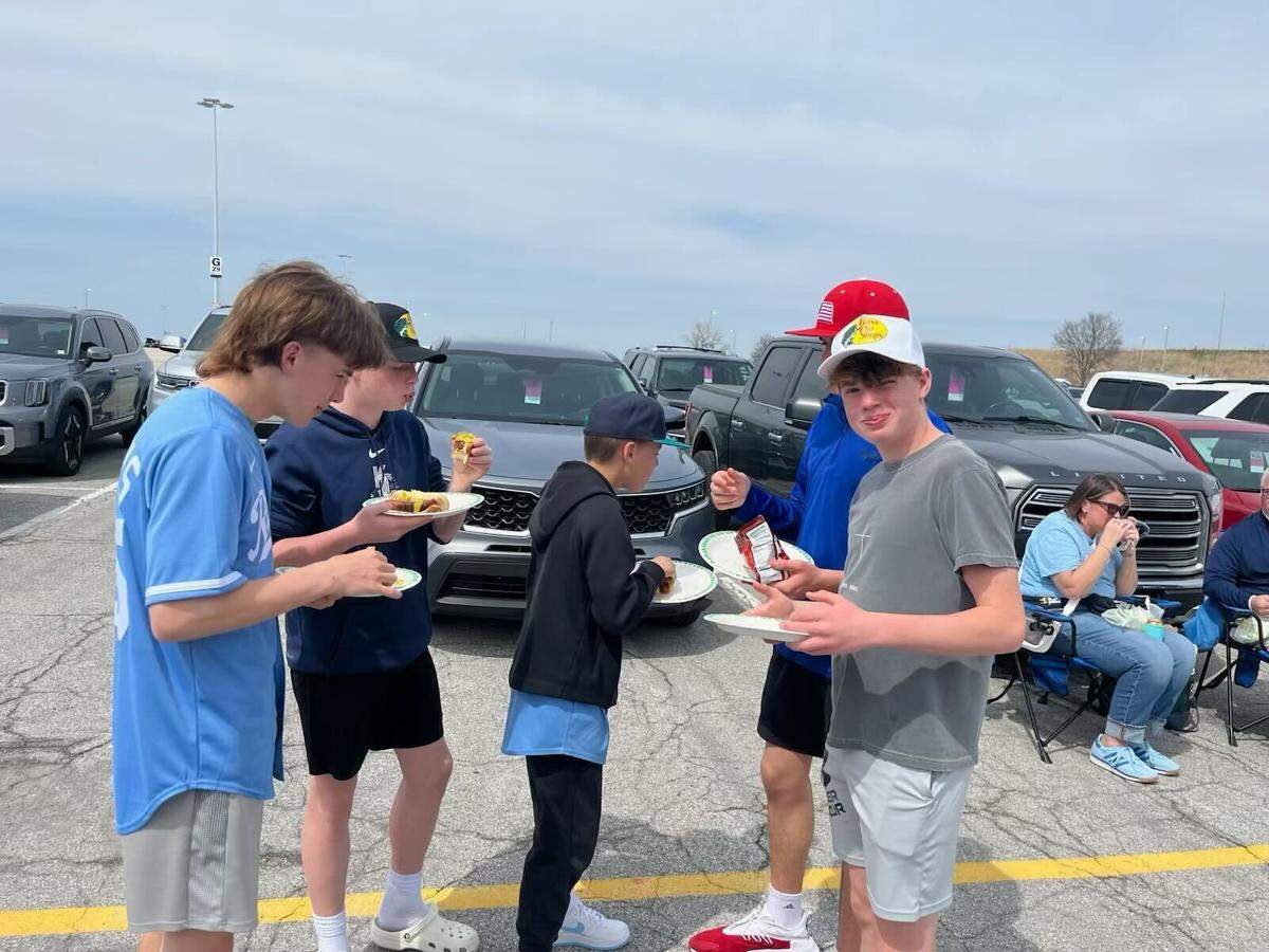 Lewis Friederich (center) is surrounded by friends tailgating before the Royals’ opening day game Thursday, March 27.