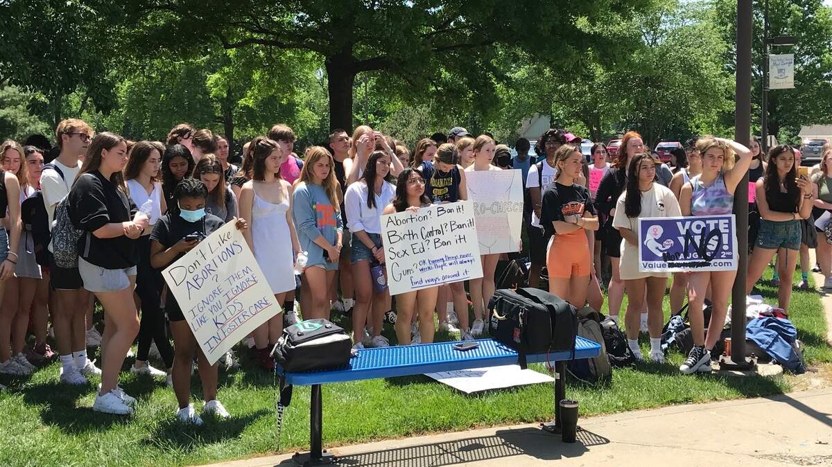 Around 200 Blue Valley North High School students hold signs in support of reproductive rights at a walkout protest over Roe v. Wade on Thursday, May 12.