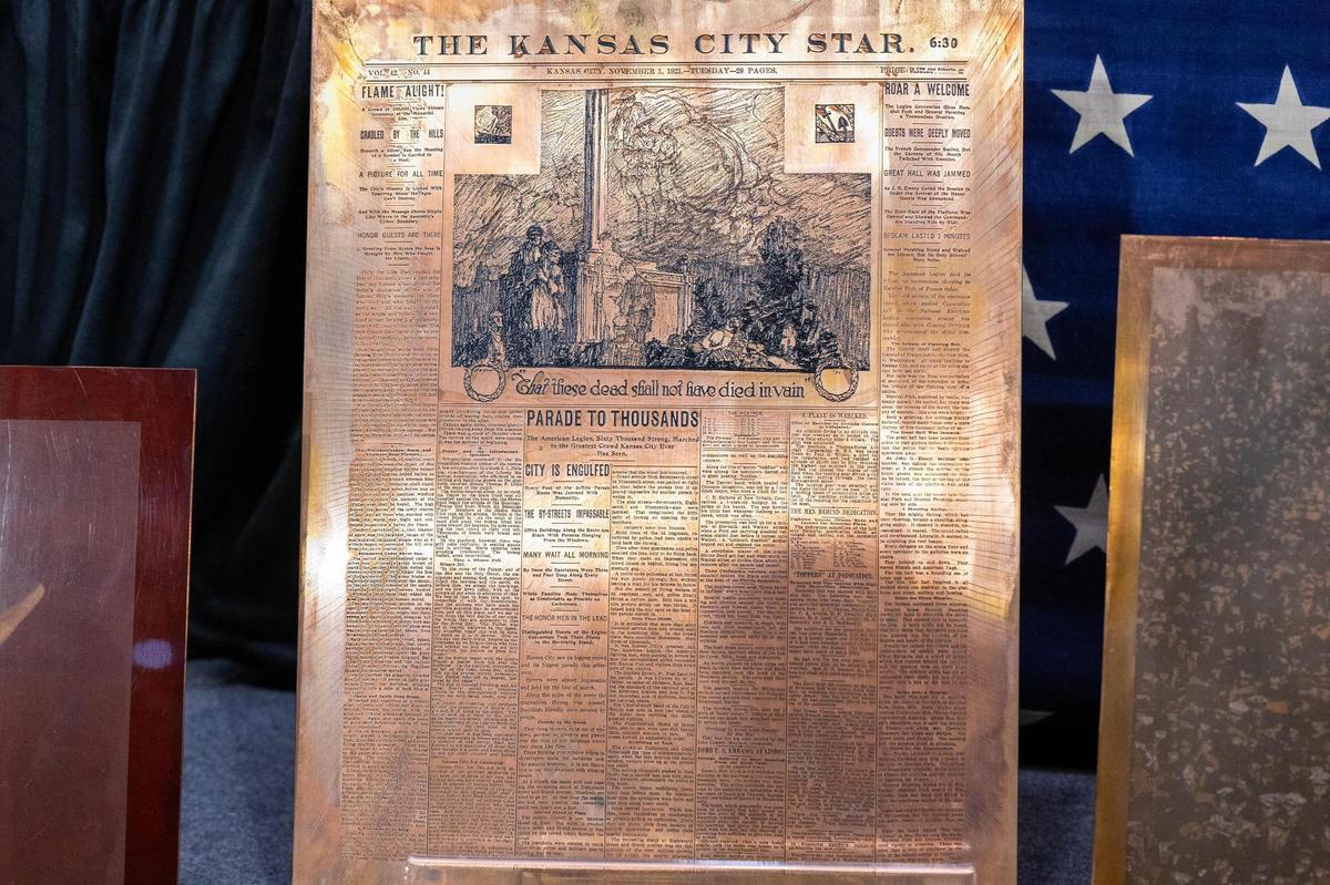 The front cover of the Kansas City Star newspaper, engraved on a copper plate, is displayed on stage during the unveiling ceremony of a 100-year-old time capsule at the National WWI Museum and Memorial in Kansas City on Wednesday, Oct. 16, 2024.