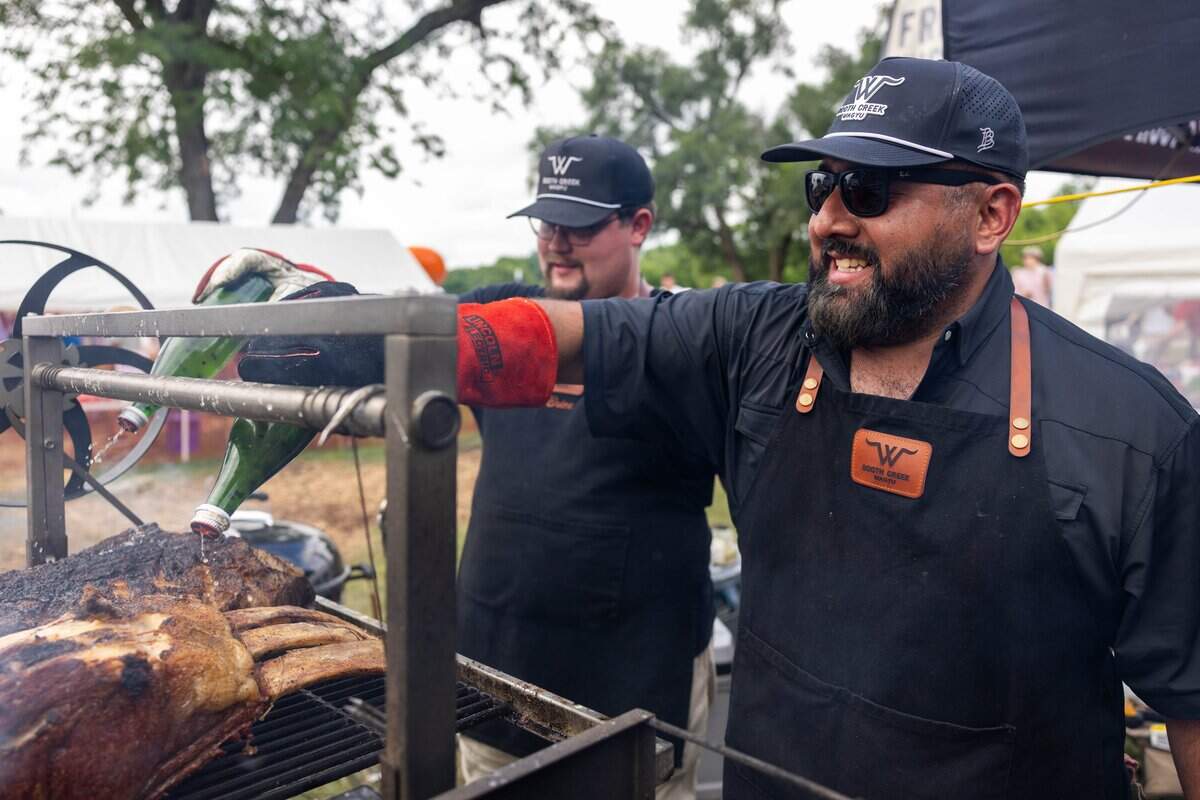 Marketing Director of Booth Creek Wagyu, Ben Fuentes splashes the beef with marinade at The Great Lenexa BBQ Battle on Friday, June 26, 2026. Booth Creek Wagyu, one of the five sponsors of this years battle, offered free samples to the public attending the event.