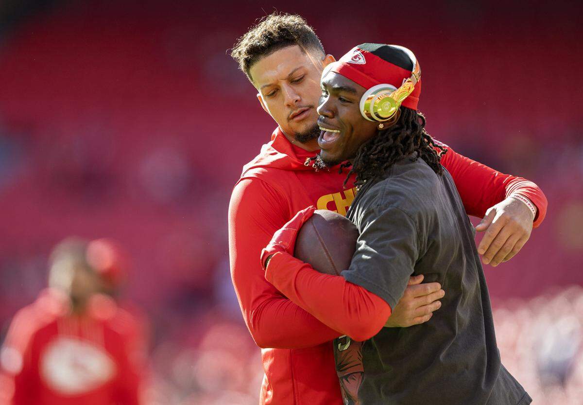 Kansas City Chiefs quarterback Patrick Mahomes (15) hugs Kansas City Chiefs wide receiver Rashee Rice (4) during warmups for the game against the Las Vegas Raiders on Sunday, October 19, 2025, at GEHA Field at Arrowhead Stadium in Kansas City.