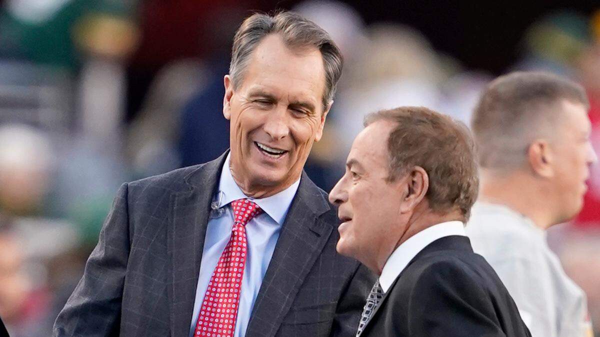 Cris Collinsworth, left, and Al Michaels before an NFL football game between the San Francisco 49ers and the Green Bay Packers in Santa Clara, Calif., Sunday, Nov. 24, 2019. (AP Photo/Tony Avelar)