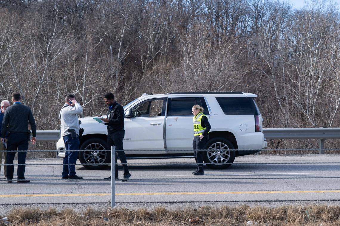 Police surround a white SUV after an alleged murder on Southbound 71 Highway and Blue River Road on Wednesday, January 7, 2026. Traffic was being diverted as the section of the highway remains closed.
