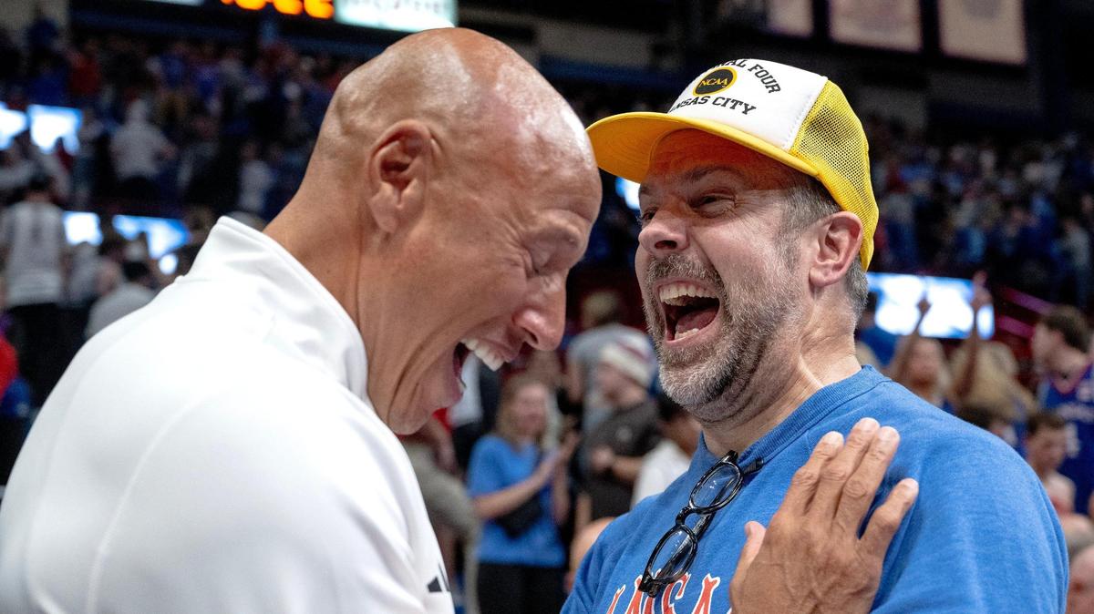 Actor Jason Sudeikis celebrates with Fred Quartlebaum, the Kansas Jayhawks’ director of basketball operations, after the Jayhawks’ 69-65 win over the Connecticut Huskies on Friday in Lawrence.