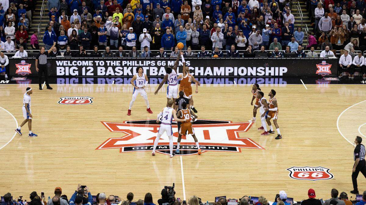 Kansas Jayhawks forward KJ Adams Jr. (24) and Texas Longhorns forward Dillon Mitchell (23) jump for the opening tip at T-Mobile Center on March 11, 2023.