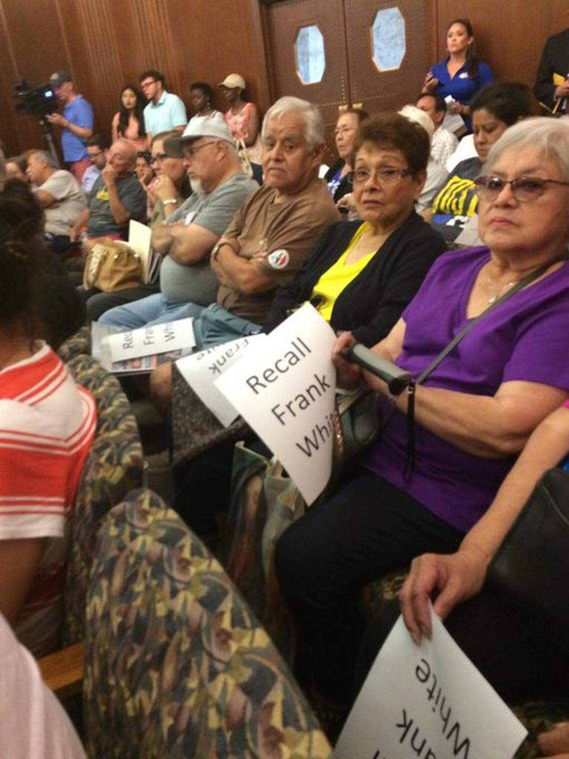 Residents of Kansas City’s West Side neighborhood brought signs calling for Frank White’s recall at a meeting of the county legislature in 2019.