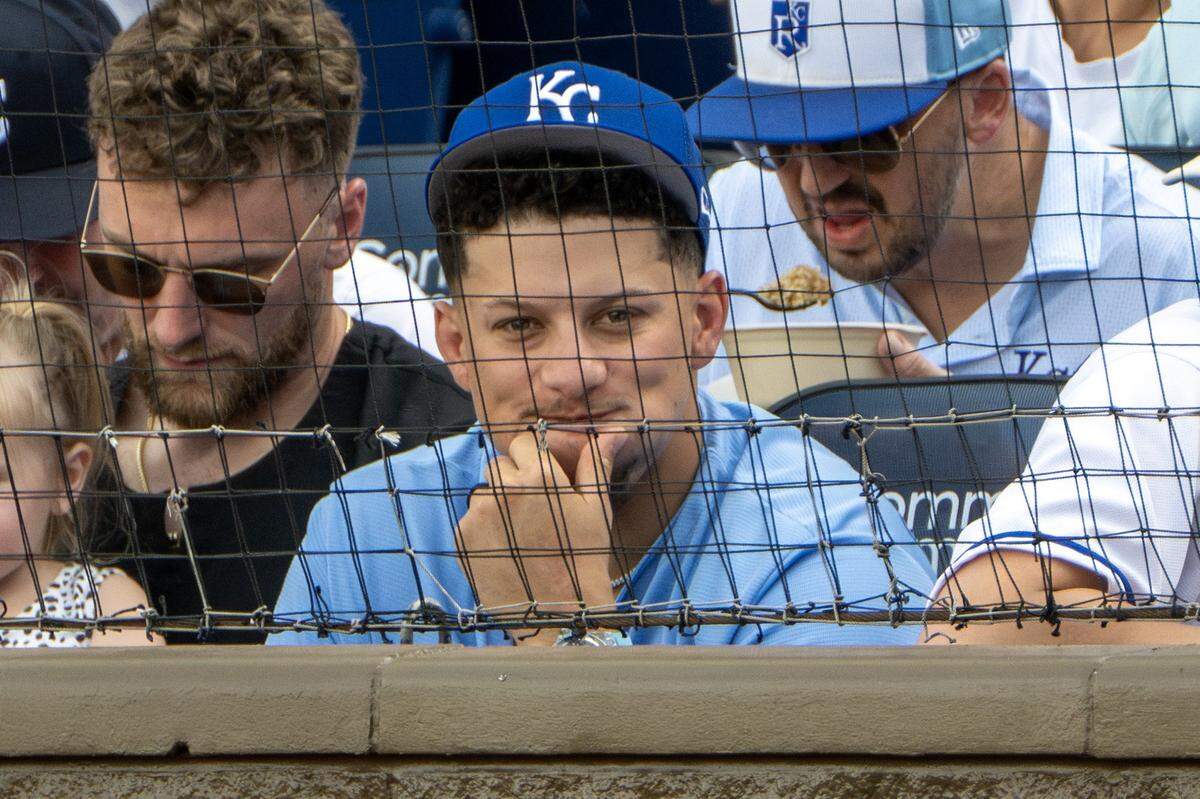 Kansas City Chiefs quarterback Patrick Mahomes, center, attends the home opener between the Kansas City Royals and the Minnesota Twins at Kauffman Stadium on Monday, March 30, 2026, in Kansas City.