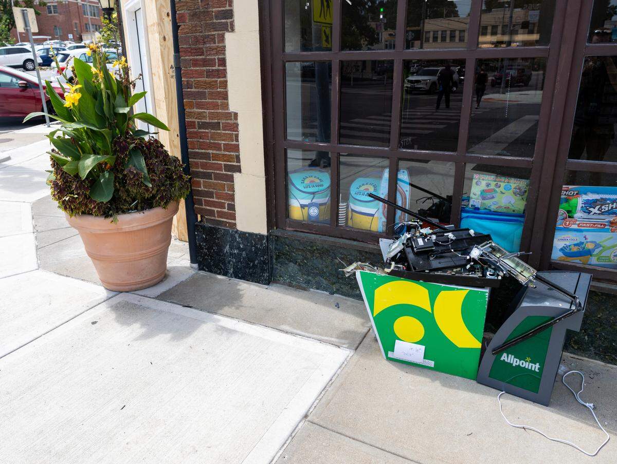 A mangled ATM sits on the sidewalk outside the CVS location at West 63rd Street and Brookside Boulevard in Kansas City. The front of the business was damaged in an apparent break-in on the morning of Friday, Aug. 23.