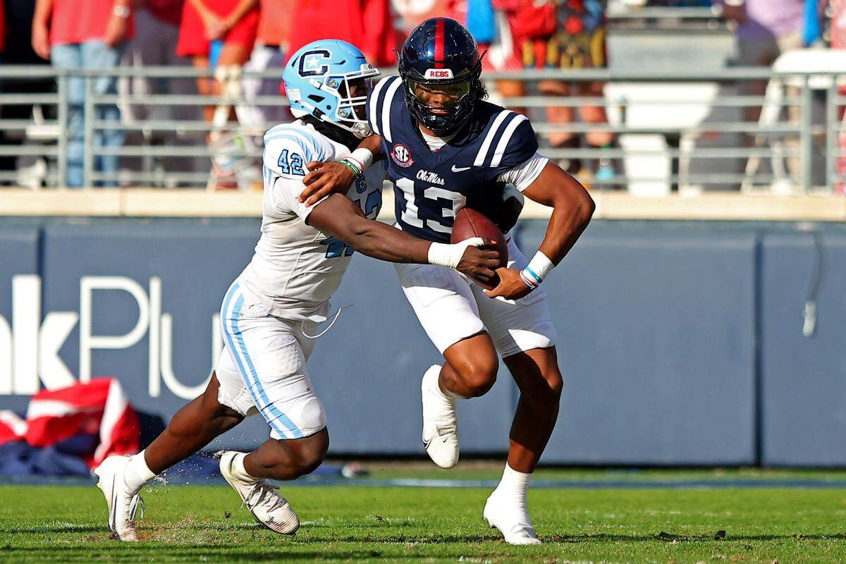Ole Miss quarterback Austin Simmons, right, shakes off would-be tackler Darryle Ware of the Citadel during a Nov. 8, 2025 college football game in Oxford, Mississippi.