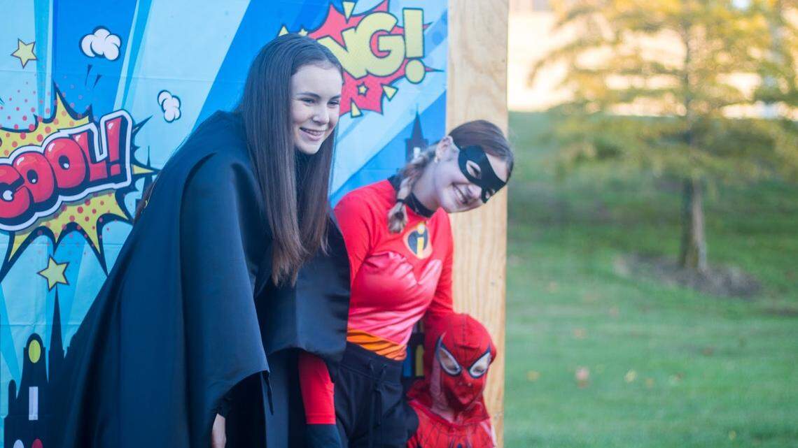 Emma Sales and Sydney Uher are on the trick or treat trail, sponsored by the city. Sydney Uher, a junior at Olathe Northwest, serves on the teen council. Emma Sales is Batman.
