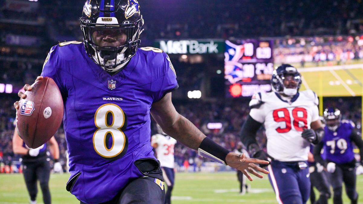 Baltimore Ravens quarterback Lamar Jackson (8) reacts after running past for Houston Texans defensive tackle Sheldon Rankins (98) for a touchdown during the fourth quarter in a 2024 AFC divisional round game at M&T Bank Stadium.