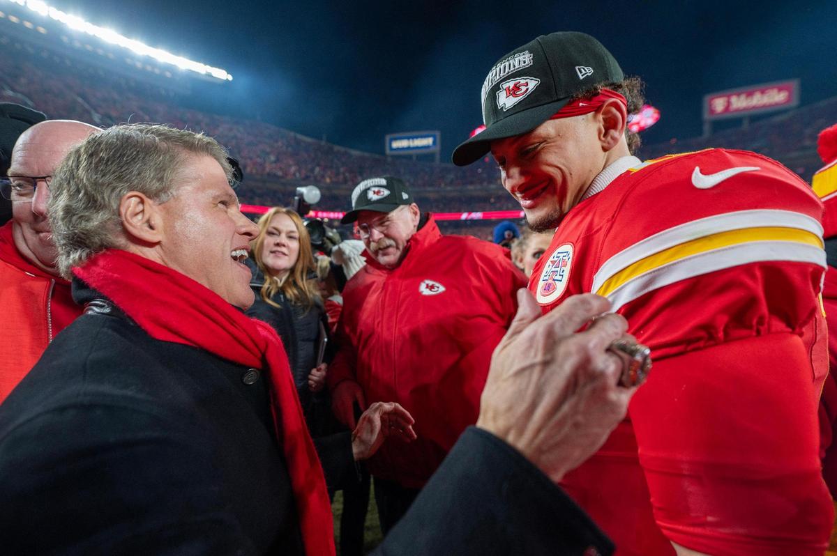 Kansas City Chiefs owner Clark Hunt congratulates quarterback Patrick Mahomes (15) as they await the trophy presentation after their 32-29 victory over the Buffalo Bills in the AFC Championship Game on Sunday, Jan. 26, 2025, at GEHA Field at Arrowhead Stadium.