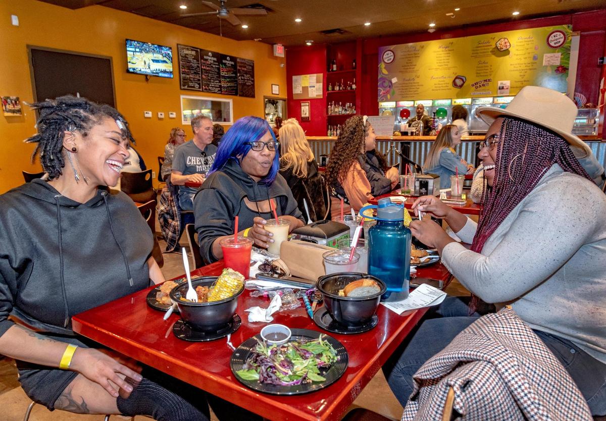 Kariesha Johnson, from left, Alayshaa Bland and Zahra Briggs chatted during their visit in 2022 to the all-vegan Black History Month Creole brunch at KC Daiquiri Shop, 1116 Grand Blvd.