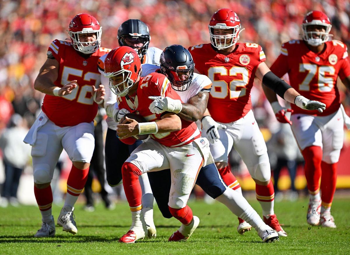 Kansas City Chiefs quarterback Patrick Mahomes (15) gets sacked by Denver Broncos defensive end Zach Allen (99) in the first half on Sunday, Nov. 10, 2024, at GEHA Field at Arrowhead Stadium.