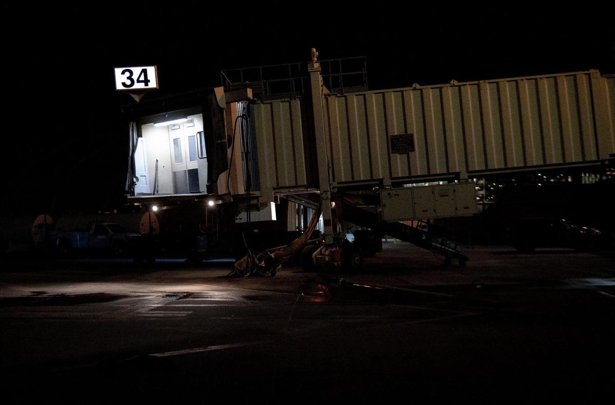 Lights from a jet bridge illuminate the tarmac outside of terminal B on the last day of operation at Kansas City International Airport’s old terminals on Monday, Feb. 27, 2023, in Kansas City.