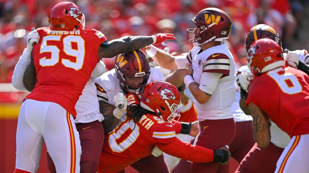 Kansas City Chiefs defensive end Joshua Kaindoh (59) and defensive tackle Taylor Stallworth (90) go after Washington Commanders quarterback Sam Howell (14) in the first half on Saturday, Aug. 20, 2022, at Arrowhead Stadium in Kansas City.