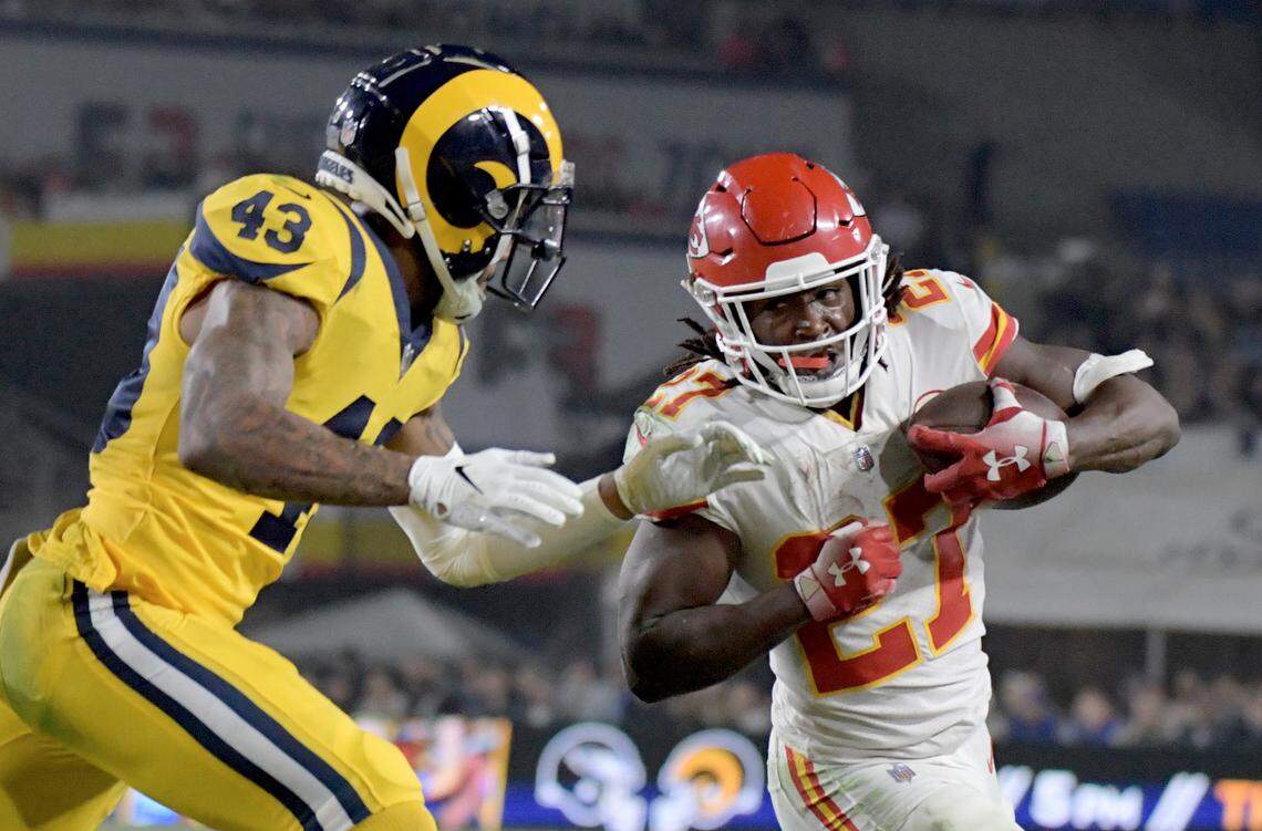 Los Angeles Rams safety John Johnson (43) tackles Kansas City Chiefs running back Kareem Hunt (27) during the first half at the Los Angeles Memorial Coliseum on Nov. 19, 2018.