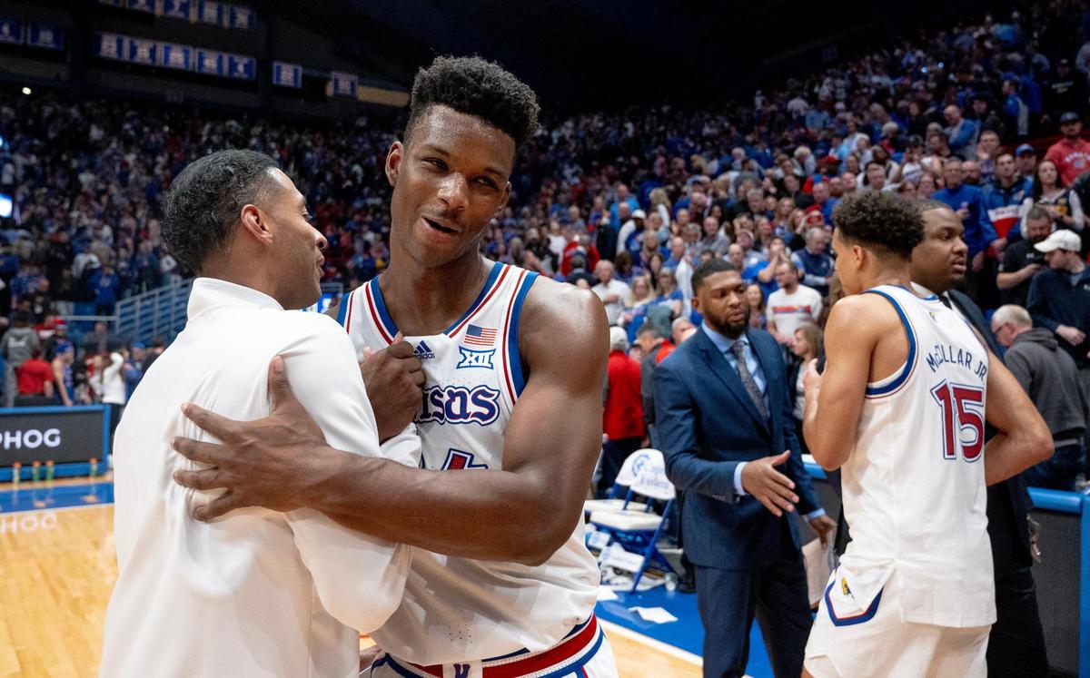 Kansas Jayhawks forward K.J. Adams Jr. (24) celebrates with assistant coach Jeremy Case after the Jayhawks’ 69-65 win over the Connecticut Huskies in an NCAA basketball game on Friday, Dec. 1, 2023, in Lawrence, Kan.