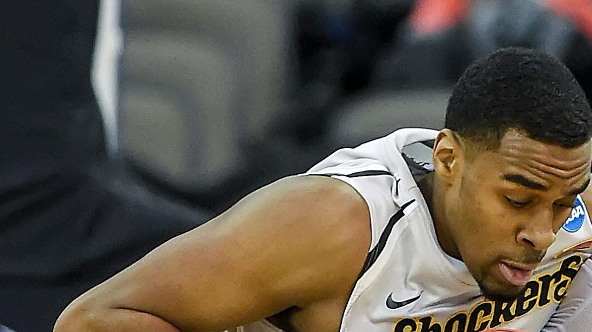 Wichita State Shockers forward Darius Carter (12) and Wichita State Shockers guard Ron Baker (31) fought for control of a rebound against the Indiana Hoosiers during the second round of the NCAA men's basketball tournament on March 20, 2015, at CenturyLink Center in Omaha, Neb.