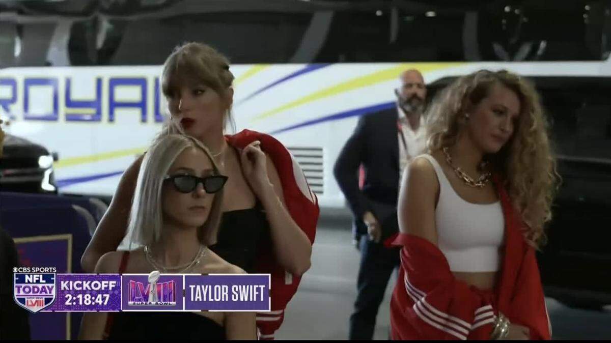 Taylor Swift wore a red Chiefs Jacket from Wear by Erin Andrews to the Super Bowl on Sunday. Her friend, actress Blake Lively, arrived with her.