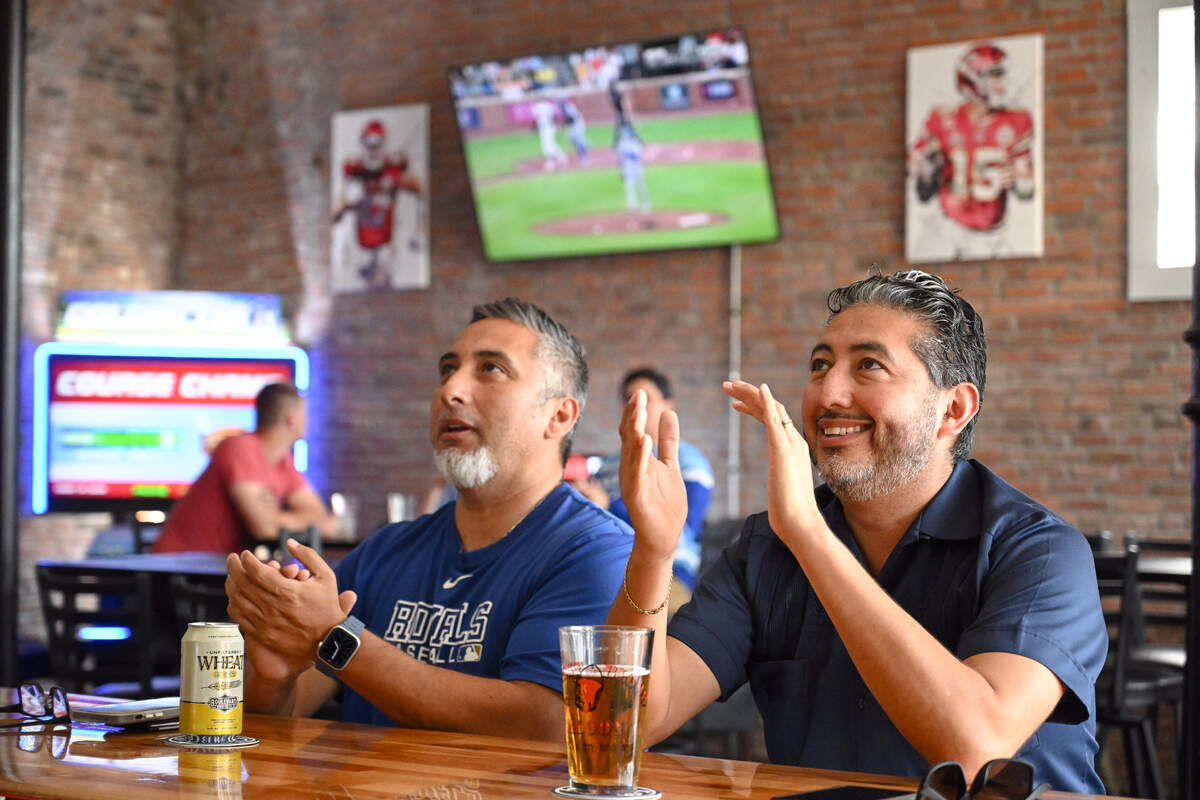 Francisco Lopez, left, Shawnee, and his brother Randy Lopez, Kansas City, Kansas cheer on the Kansas City Royals while watching the AL Wild Card game on Tuesday, Oct. 1, 2024, at The Davenport sports bar in Kansas City, Kansas, The Royals played the Baltimore Orioles in the first game of the three-game playoff series.