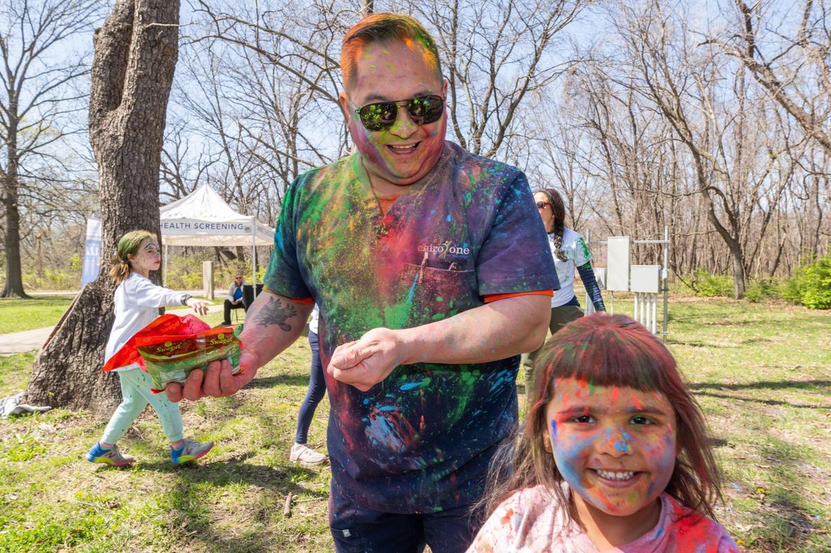 People celebrate the Hindu festival of Holi in Overland Park on Sunday.
