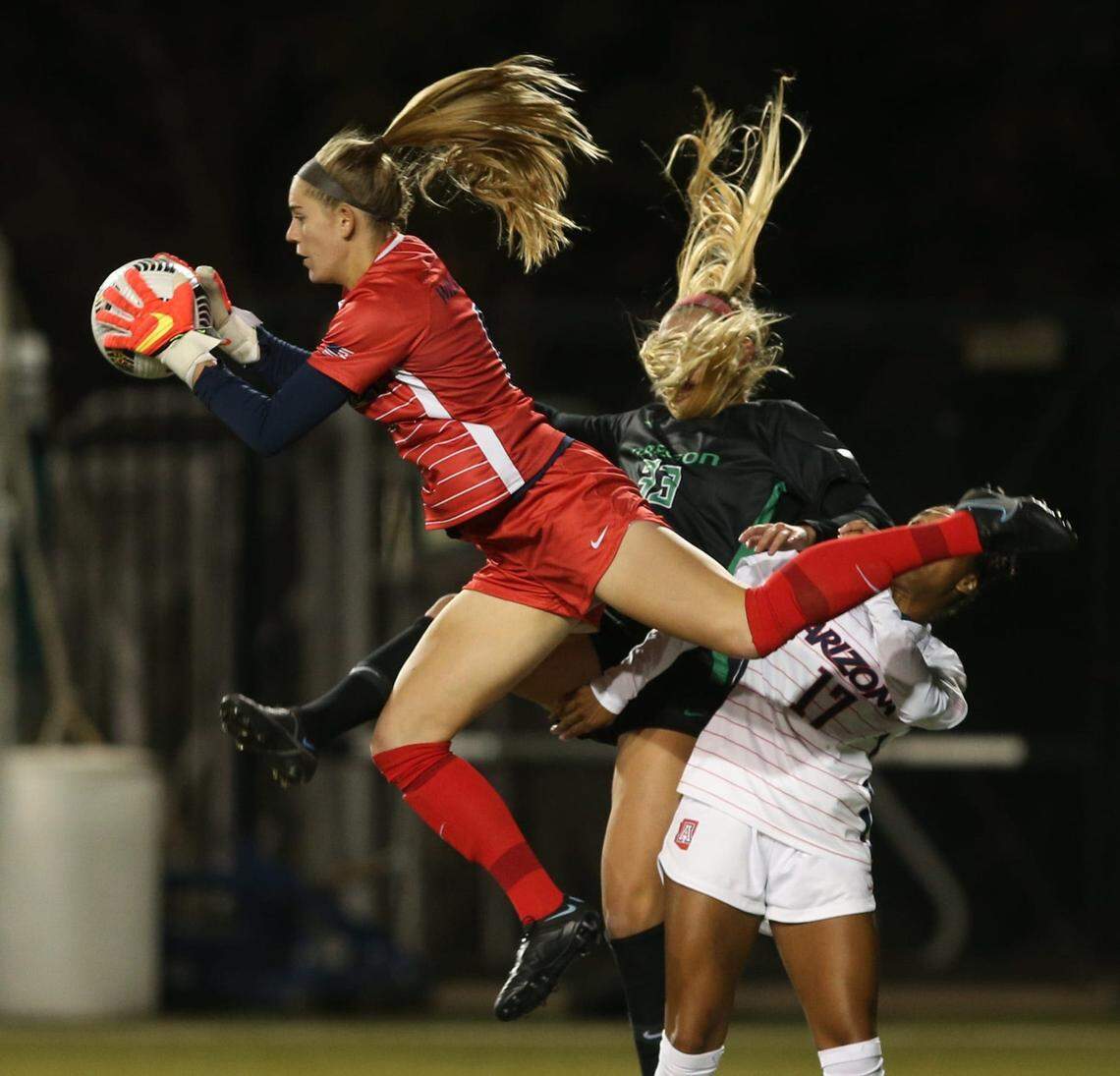 Goalkeeper Hope Hisey dives to block a shot for Arizona during a 2021 match against Oregon.