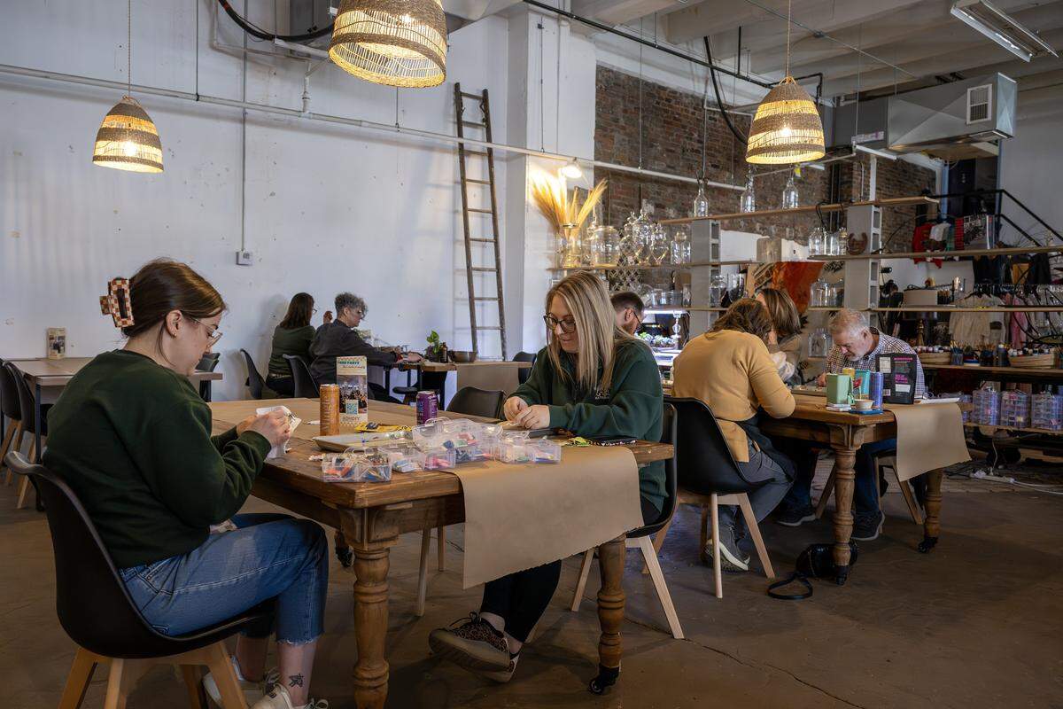 Guests sit at tables while making crafts at ADHDIY Craft Cafe on Saturday, Feb. 7, 2026, in Kansas City.