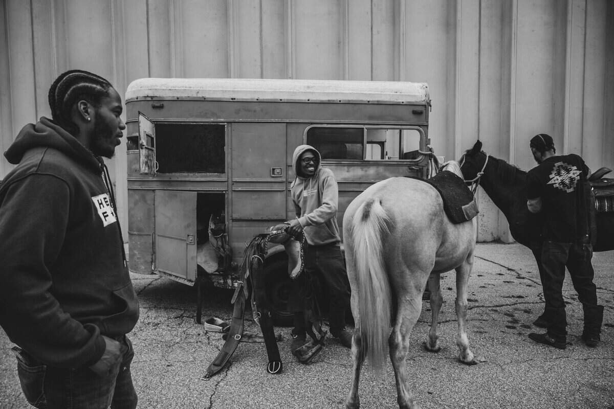 The Copper Boyz prep ‘Goldie’ and ‘Black Jack’ for saddles before a community outreach ride with KCPD in Kansas City. The police welcome the attention the horses bring and use it to their advantage as a means to reach people in the community that would otherwise not bother to interact with police.